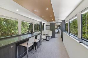 a room with windows and a bar with stools at Studio 7744 Ranch Austin Venue and Rentals in Austin