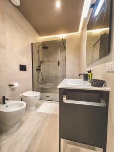 a bathroom with a sink and a toilet and a shower at AF Apartments in Lecce