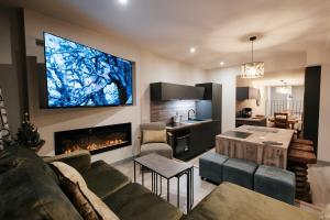 a living room with a couch and a fireplace at Alpaka Mountain Lodge - The Perfect Summer Holiday in Tignes