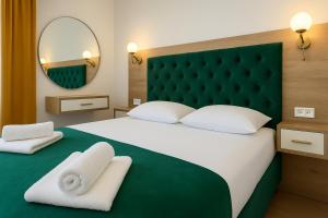 Postel nebo postele na pokoji v ubytování Apartmani Enydoo