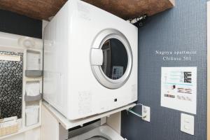 a washing machine in a bathroom with a mirror at Prosper 5th bldg 501 in Nagoya