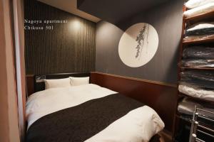 a small bedroom with a bed and a closet at Prosper 5th bldg 501 in Nagoya