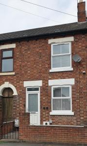 a brick house with white windows and a door at Miner's Retreat Comfy 2-Bed Home, Swadlincote in Woodville