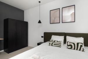 a bedroom with a bed with black and white pillows at Villa Lapidea in Vodice +36 photos