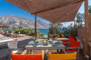 a table and chairs with a view of the ocean at Petradi Studios & Villa in Aegiali