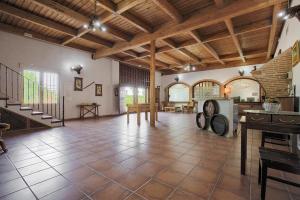 a large room with a tile floor and wooden ceilings at Hotel Finca Biazu in Ocaña