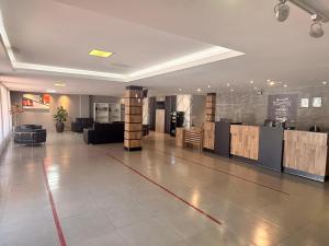 a large lobby with a reception desk in a building at Itaipu Hotel in Foz do Iguaçu