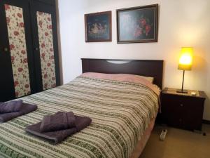 a bedroom with a bed with two towels on it at Cosy Penthouse -up to 6 guests- in the City Centre! in Thessaloniki