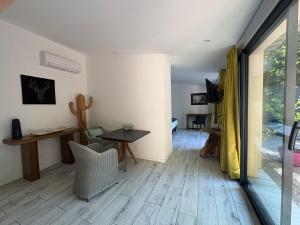 a living room with a wooden floor and a table at Domaine Shambala - gîte en Provence avec une Grande Piscine in Velaux