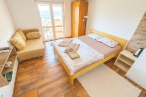 a small bedroom with a bed and a couch at Apartment Sea & Mountain in Bar