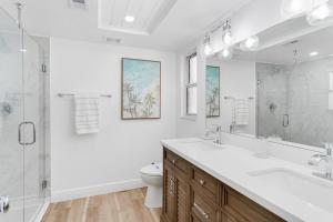 a bathroom with a sink and a toilet and a shower at Modern Coastal Home in Clearwater Beach +31 photos