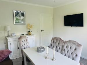 a dining room with a table and two chairs at Maison Lily Apartment 5 in Bad Lauterberg