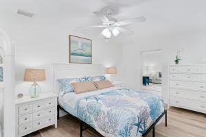 a bedroom with a bed and a ceiling fan at Modern Coastal Home in Clearwater Beach
