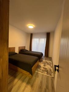 a bedroom with two beds and a window at Art superior apartment in Kosovo Polje