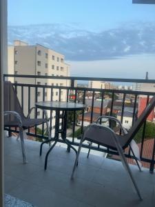 a table and chairs on a balcony with a view at Art superior apartment in Kosovo Polje