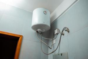 a light on a wall in a bathroom at Edrin Apartments in Kampala