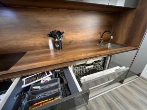 a kitchen with a counter top with a sink at Art superior apartment in Kosovo Polje