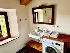a bathroom with a washing machine and a sink at Casa Ancarano Historic Cottage Panoramic position sea 3km 4-8pers in Sirolo