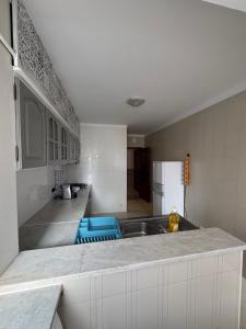 a kitchen with a sink and a counter top at Cozy Abadias Apartment in Figueira da Foz
