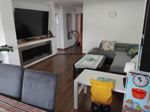 a living room with a couch and a table at Apartament/Pietro domu in Charzykowy