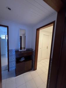 an empty room with a door and a mirror at Cozy Abadias Apartment in Figueira da Foz +16 photos