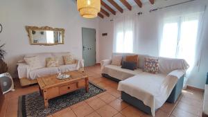 a living room with two couches and a coffee table at Casa Verde Oliva in Sedella +103 photos