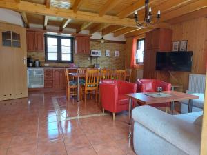 a kitchen and living room with a table and chairs at Domki DUET in Dźwirzyno
