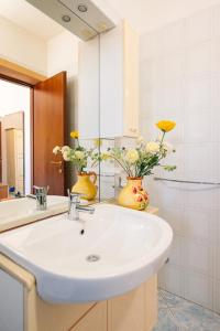 a bathroom with a sink and two vases with flowers at Posto Cantoro in Marina di Pescoluse +25 photos
