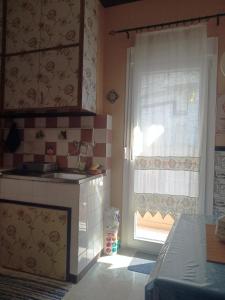 a small kitchen with a sink and a window at Cosy Penthouse -up to 6 guests- in the City Centre! in Thessaloniki