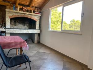 a dining room with a table and a fireplace at Apartman Toni in Bibinje