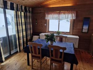 a dining room table with a potted plant on it at Stall Rygg Apartment, Gloppen in Rygg