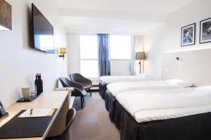 Ένα ή περισσότερα κρεβάτια σε δωμάτιο στο Best Western RC Hotel