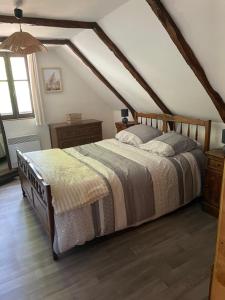 a bedroom with a bed in a attic at Chaumière du 16-ème siècles in Saint-Augustin