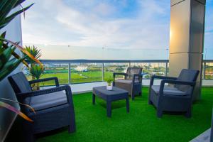 three chairs and a table on a balcony with a view at City & Stadium Luxe in Tangier