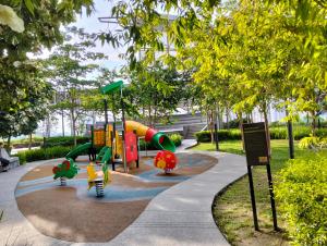 a playground with a slide in a park at Homestay at Trion KL in Kuala Lumpur