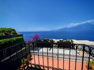 a view of the ocean from a balcony with a fence at SG Luxury - Pieds dans l eau Torri in Torri del Benaco