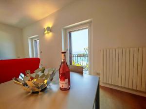 a bottle of wine sitting on top of a table at SG Luxury - Pieds dans l eau Torri in Torri del Benaco