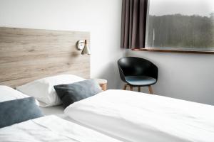 Postel nebo postele na pokoji v ubytování Hotel Juelsminde Strand