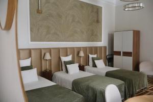 Posteľ alebo postele v izbe v ubytovaní Harmonia Palace