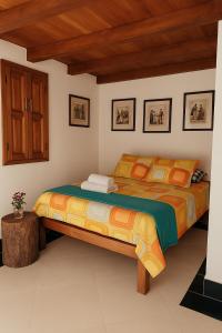a bedroom with two beds and a wooden ceiling at La Ramada in Abejorral +34 photos