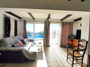 a living room with a couch and a large window at Casa Carámbila in Cómpeta