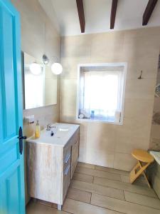 a bathroom with a sink and a window at Casa Carámbila in Cómpeta