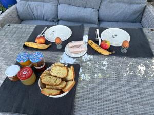 a table with a plate of bread and fruit and drinks at Bastide de Garidelle in Callas
