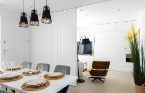 a dining room with a white table and chairs at Cactus Apartment La Ribera in Santiago de la Ribera +109 photos