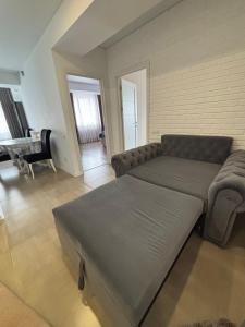 a living room with a couch and a table at Apartament de lux, 2 dormitoare! in Chişinău