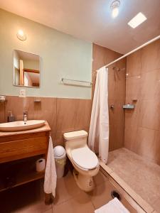 a bathroom with a toilet and a sink and a shower at Gaia Guest House in San Cristóbal de Las Casas +76 photos