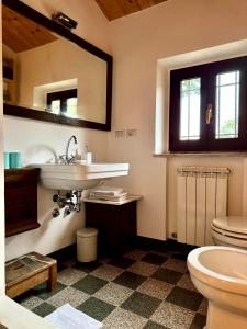 a bathroom with a sink and a toilet at Casa Ancarano Historic Cottage Panoramic position sea 3km 4-8pers in Sirolo