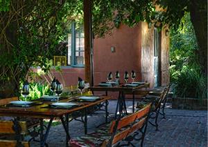 a group of tables and chairs with wine glasses on them at Puesto Viejo in Cañuelas