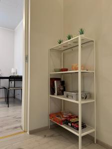 a white book shelf in a living room at Mai 10 apartment in Pärnu