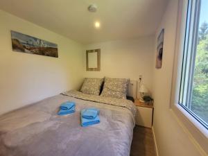 a bedroom with a bed with blue towels on it at Bungalow Maya in Lauchhammer